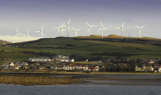 Wind farms, such as this one above Ardrossan, are very much a part of Scotlands landscape. Picture: Donald MacLeod
