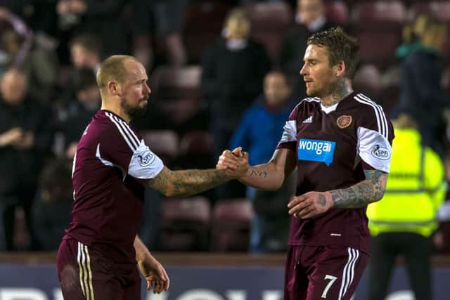 Ryan Stevenson, right, with scorer Jamie Hamill after the final whistle as Hearts avoided relegation. Picture: SNS
