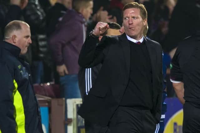 Gary Locke punches the air after Hearts level the score. Picture: SNS
