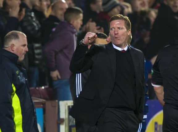 Gary Locke punches the air after Hearts level the score. Picture: SNS