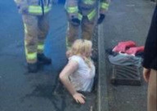 Firefighters with Ella Birchenough who tried  and failed  to fish out her dropped phone. Picture: PA