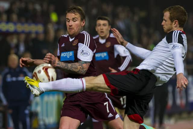 Ryan Stevenson, left, challenges Mark Reynolds during Hearts draw with Aberdeen, which delayed relegation again. Picture: Sammy Turner/SNS