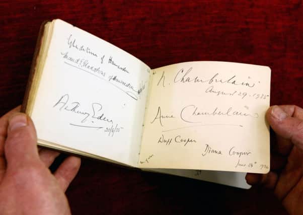 The signatures of Anthony Eden and Neville Chamberlain inside a book of autographs. Picture: AP
