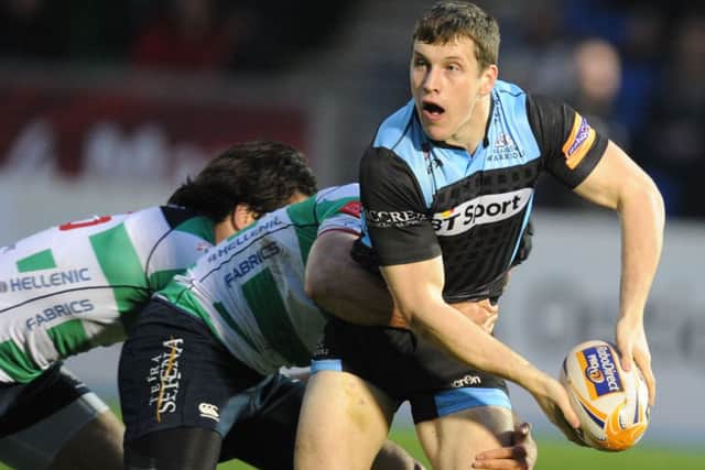 Warriors centre Mark Bennett looks to release the ball as he's tackled. Picture: SNS