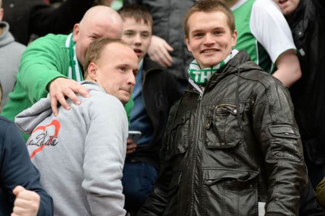 Leigh Griffiths poses for photos with Hibs fans in the away end at Tynecastle. Picture: SNS