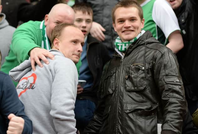 Leigh Griffiths poses for photos with Hibs fans in the away end at Tynecastle. Picture: SNS