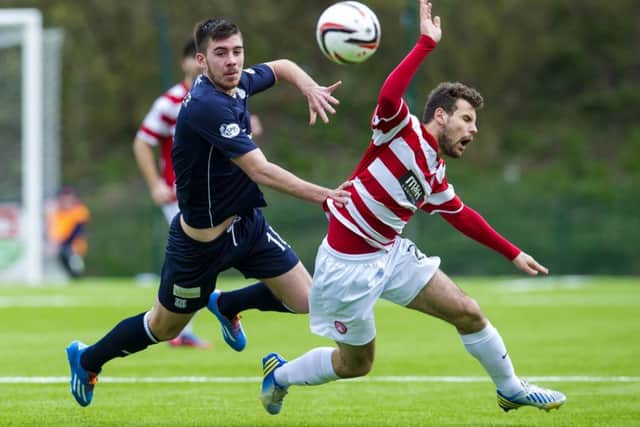 Hamiltons Tony Andreu, right, is tackled by Dundees Declan Gallagher during yesterdays top-of-the-table clash. Photograph: SNS Group