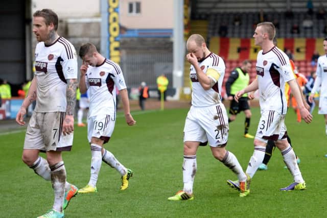 The dejected Hearts squad traipse off the Firhill pitch after hearing of St Mirren's late win. Picture: SNS