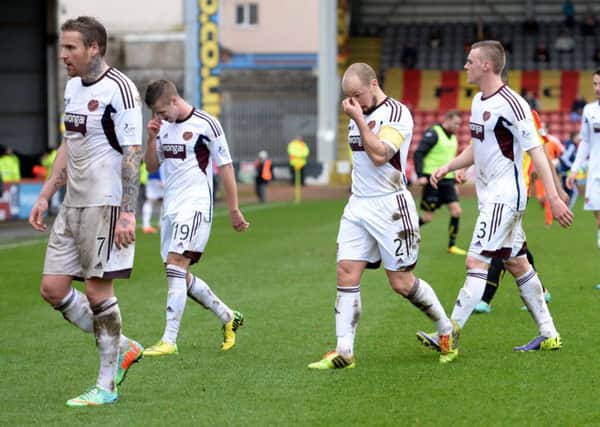 The dejected Hearts squad traipse off the Firhill pitch after hearing of St Mirren's late win. Picture: SNS