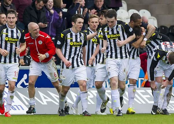 St Mirren players mob Stephen Thompson after his second, and St Mirren's third gave them an unlikely win. Picture: SNS