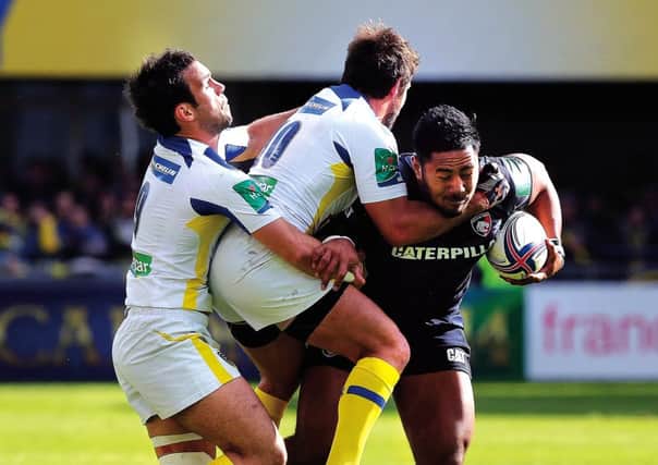 Clermont half-backs Brock James and Morgan Parra double up to halt the progress of Leicesters Manu Tuilagi. Photograph: Getty Images