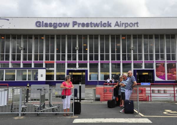 Passengers wait outside Prestwick Airport. Picture: Robert Perry