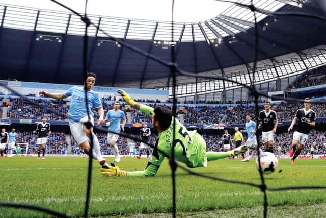 Samir Nasri takes advantage of a pass from an offside David Silva to put Manchester City ahead.  Photograph: Darren Staples