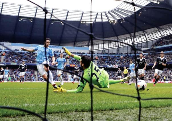 Samir Nasri takes advantage of a pass from an offside David Silva to put Manchester City ahead.  Photograph: Darren Staples