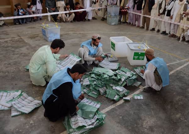Election officials count votes at a station in Kandahar/ Pictures: AFP/Getty Images