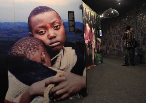 Visitors in the Kigali Genocide Memorial Museum look at images of the 1994 Rwandan genocide. Picture: Reuters