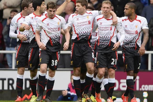 Steven Gerrard, centre, is congratulated after scoring the Reds second. Picture: Reuters