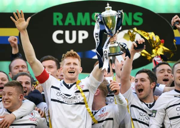 Ratih Rovers captain Jason Thomson celebrates after winning the Ramsdens Cup. Picture: SNS