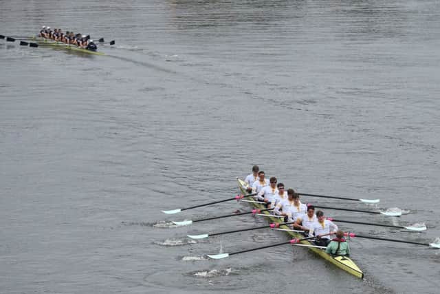 Oxfords crew celebrate in style with a large bottle of Bollinger champagne. Picture: AP Photo