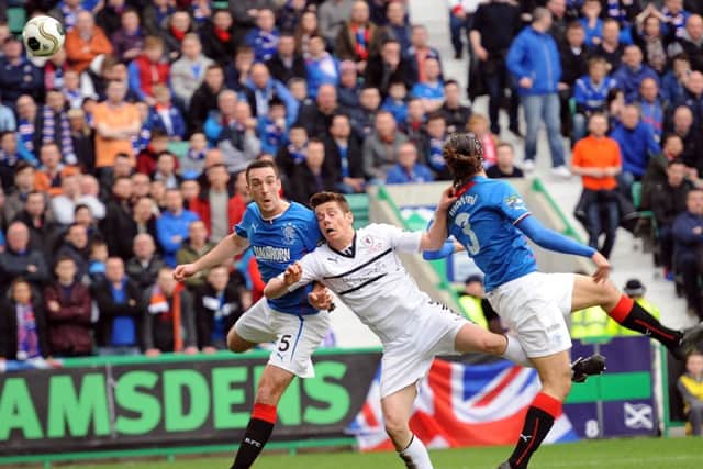 Lee Wallace and Bilel Mohsni compete with Dougie Hill in the final of the Ramsdens Cup. Picture: Neil Doig