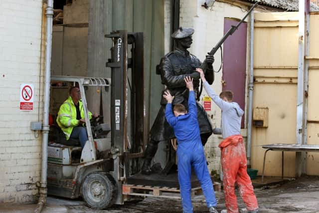 Workers move the bronze statue as it prepares to leave for Belgium. Picture: PA