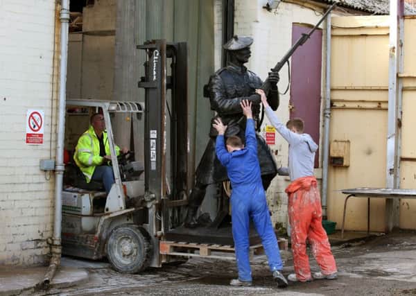 Workers move the bronze statue as it prepares to leave for Belgium. Picture: PA