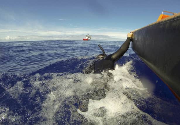 A diver is towed by a fast response craft from the Australian ship Ocean Shield as he searches for debris. Picture: AP