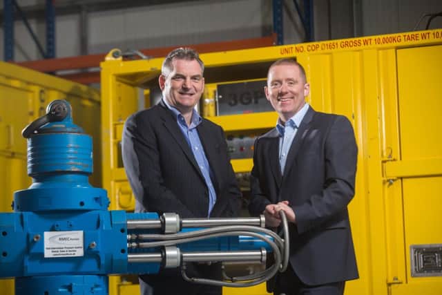 Mavens Jock Gardiner, left, and Rmec managing director Bryan Fagan celebrate the deal. Picture: Derek Ironside