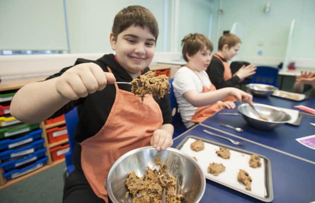 Kaius Gibb, Ben Chapman and Alexander Ford of Kaimes Special School have developed their biscuit-making business. Picture: Jane Barlow