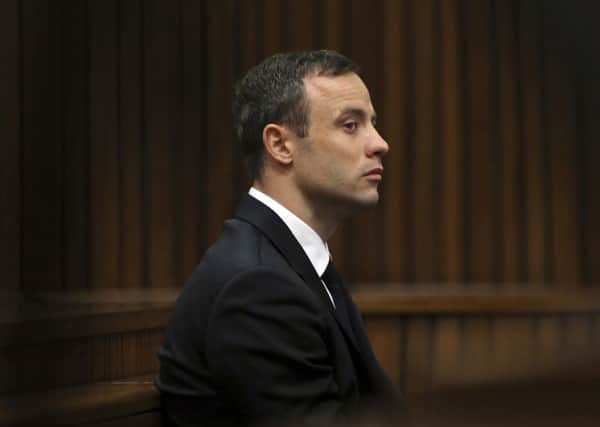 Oscar Pistorius sits in the dock at a court in Pretoria, South Africa, the athlete broke down as he described the shock at realising he had killed his girlfriend Reeva. Picture: AP