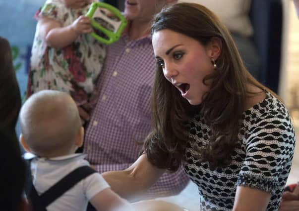 Catherine, the Duchess of Cambridge, reacts as she plays with her son Prince George. Picture: Reuters