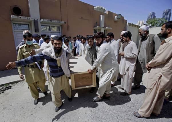 Relatives prepare to bury one of the dead from the bomb attack. Picture: AP