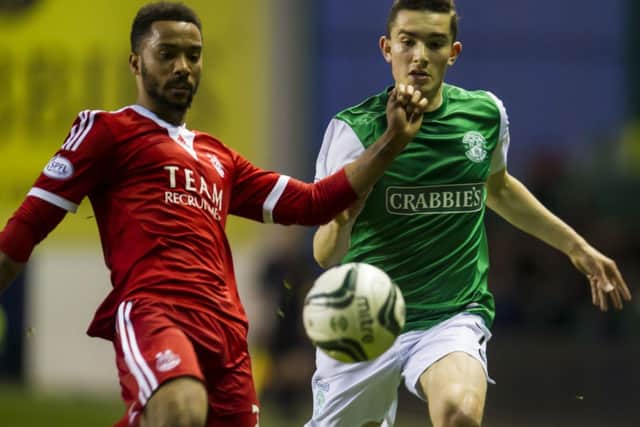 Alex Harris tussles with Aberdeen's Shaleum Logan. Picture: SNS