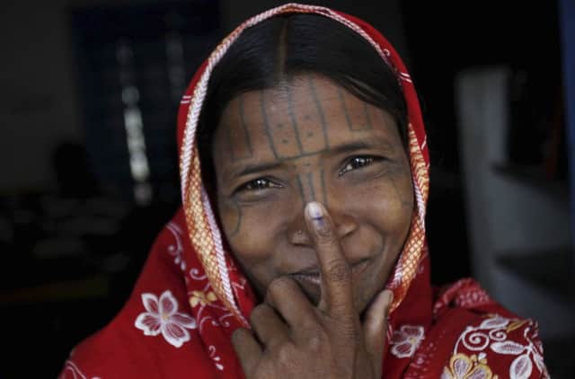 A Kandha woman shows an inked finger after voting in Orissa. Picture: AP/Getty