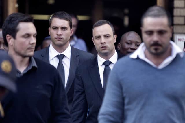 Oscar Pistorius, second right, leaves the North Gauteng High Court during his ongoing murder trial in Pretoria today. Picture: Getty