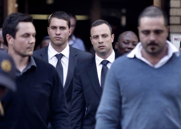 Oscar Pistorius, second right, leaves the North Gauteng High Court during his ongoing murder trial in Pretoria today. Picture: Getty
