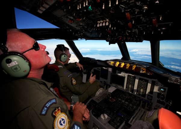 A Royal New Zealand Air Force P-3 Orion is flown by Flt. Lt Tim McAlevey back, in the search for missing Malaysia Airlines Flight MH370 over the Indian Ocean. Picture: AP