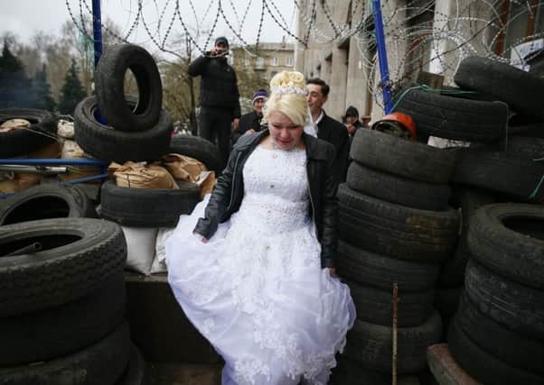 Newlyweds visit the barricade outside the regional building in the city of Donetsk. Picture: Reuters