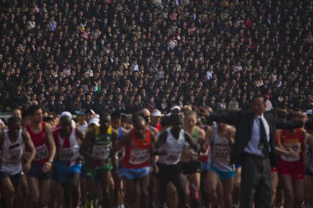 Under starters orders, a packed stadium watches as foreign runners join North Korean athletes in Pyongyang. Picture: AP