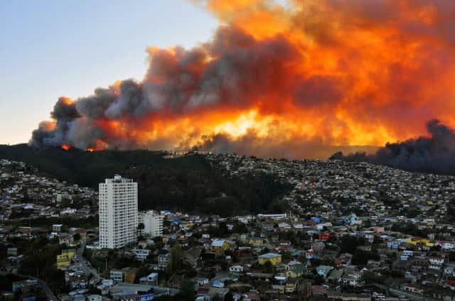 Flames light up the skyline in Valparaiso, where Chilean authorities have issued a red alert. Picture: AFP/Getty
