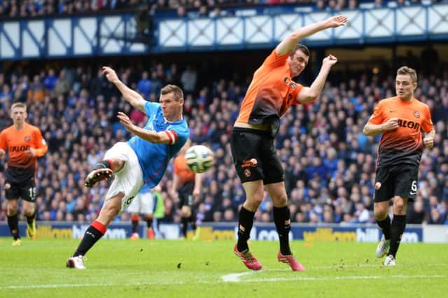 Gavin Gunning, who has been linked with Rangers, looks to block Lee McCulloch's effort. Picture: SNS