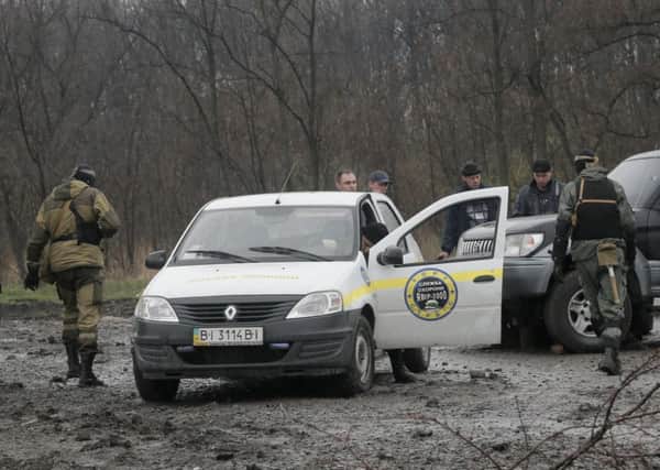 Pro-Russian gunmen inspect the scene after a firefight outside the town of Slovyansk. Picture: AP