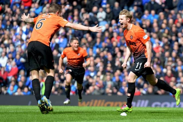 Gary Mackay-Steven, right, celebrates with Dundee United team-mates after scoring his sides second goal. Picture: SNS