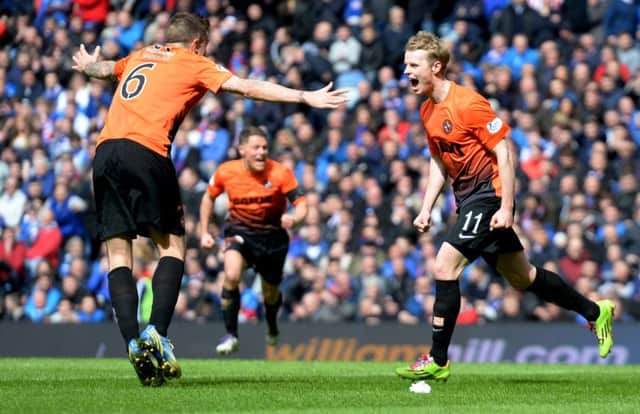 Gary Mackay-Steven, right, celebrates with Dundee United team-mates after scoring his sides second goal. Picture: SNS