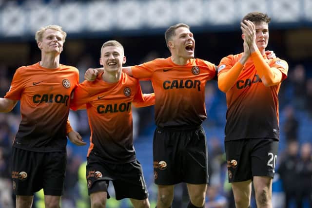 A jubilant John Rankin, second from right, celebrates with his Dundee United team-mates. Picture: SNS