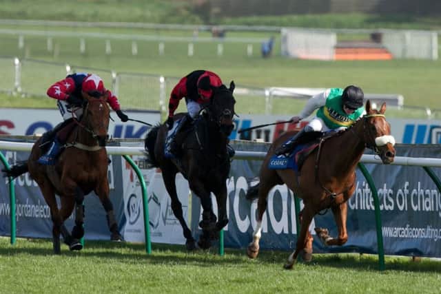 The Peter Bowen-trained Al Co, right, ridden by Jamie Moore, surges ahead of Trustan Times and Godsmejudge. Picture: PA