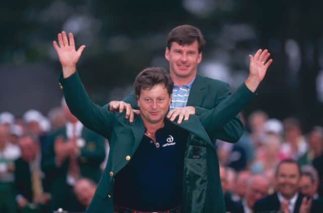 Ian Woosnam receives the famous green jacket from fellow British golfer Nick Faldo after winning the US Masters in 1991. Picture: Getty