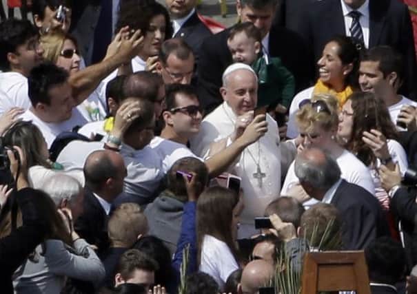 The Pope posed for photos among the crowd of 100,000. Picture: AP