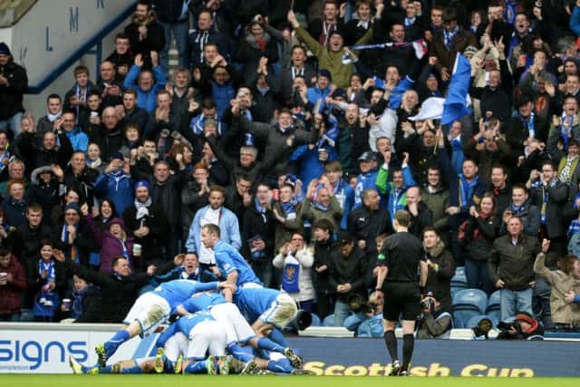 Ecstatic St Johnstone players pile on top of matchwinner Stevie May at Ibrox yesterday. Picture: Rob Casey