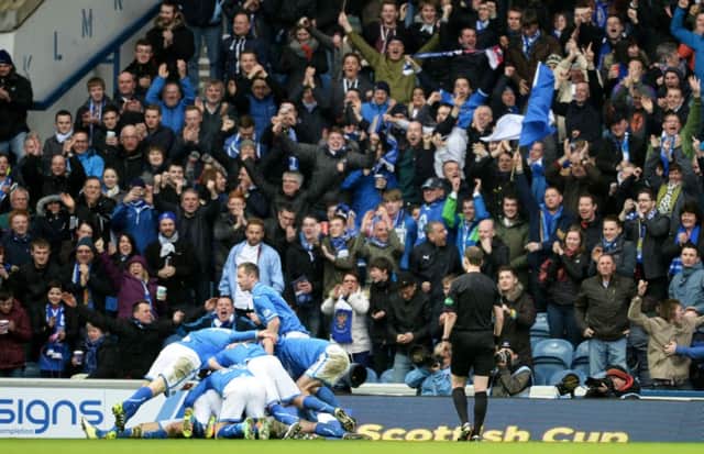 Ecstatic St Johnstone players pile on top of matchwinner Stevie May at Ibrox yesterday. Picture: Rob Casey